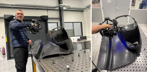 Un homme utilisant le MetraScan pour numériser une pièce d'une automobile.