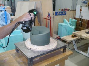 A 3D-printed sand core being scanned with the Go!SCAN SPARK. This is on a platform on a table.