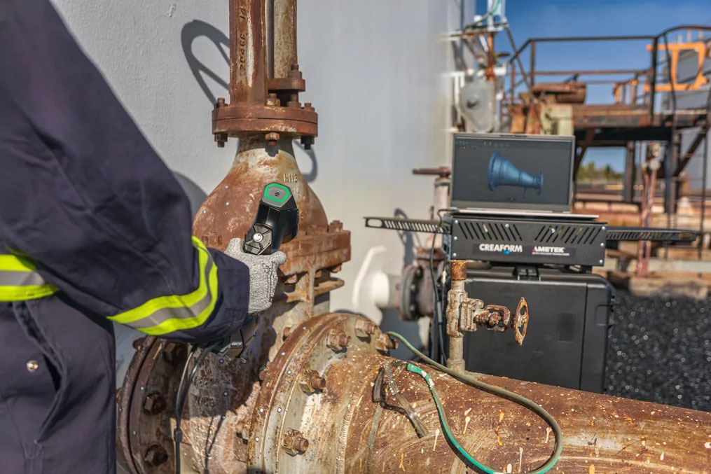 NDT technician inspecting the corrosion on a corroded valve with a metrology-grade 3D scanner