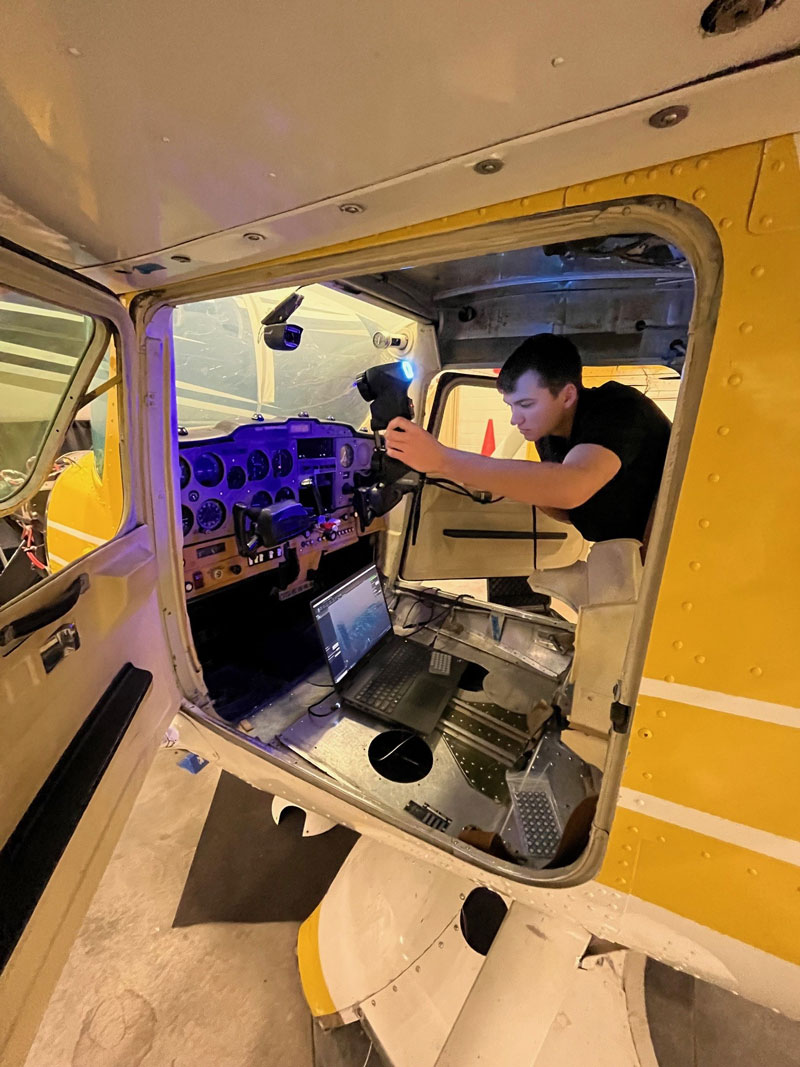 A NIAR technician 3D scans the control panel of an aircraft.