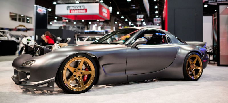 Team member using MetraSCAN 3D to scan a military vehicle hood