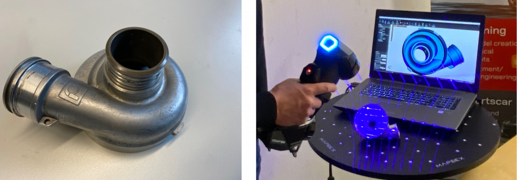 Physisches Modell eines Wasserpumpengehäuses. Ein HandySCAN 3D scannt mit blauen Laserlinien das Wasserpumpengehäuse. Man sieht den Scan in der Software auf dem Laptop.
