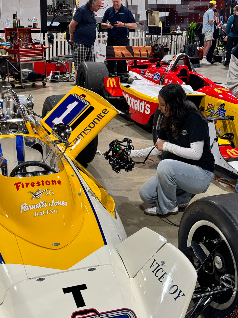 A student takes 3D measurements of a vintage race car during the Historic Indy Car Challenge at the Long Beach Grand Prix.