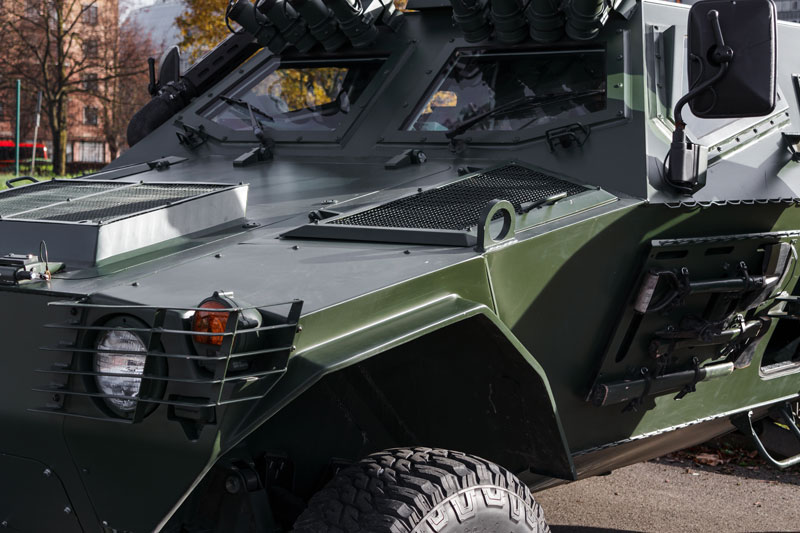 Close-up of a green armored car with several customized features