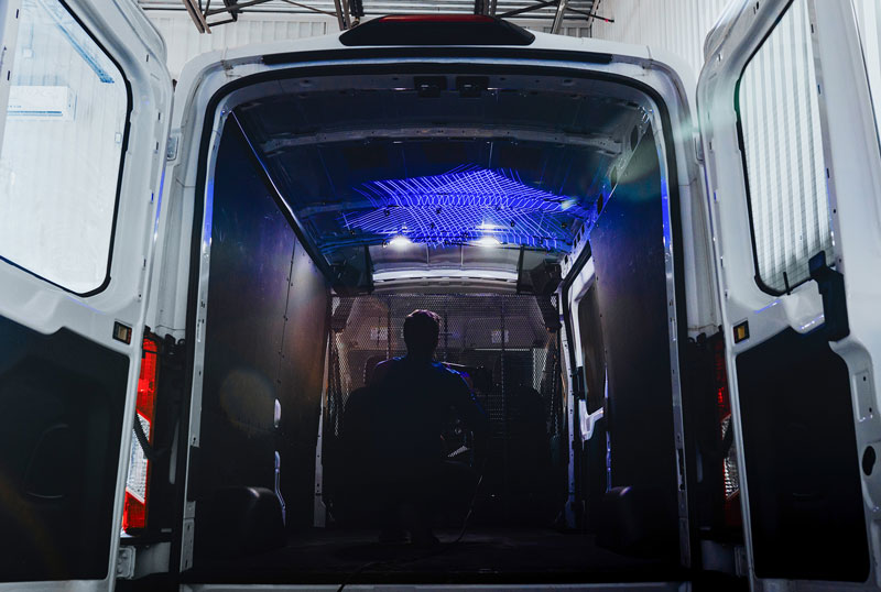 Man using the HandySCAN 3D|MAX Series scanner to scan the interior of a van for customization.