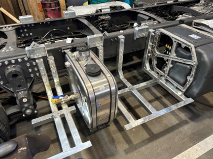 Truck chassis with additional attachment holder for toolboxes