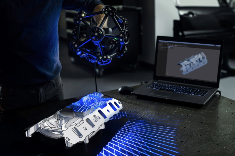 Creaform’s MetraSCAN 3D scanning a shiny part displayed in real-time on a laptop screen