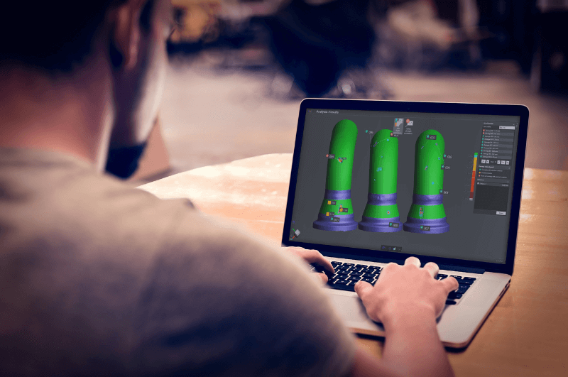 man on laptop using Creaform software