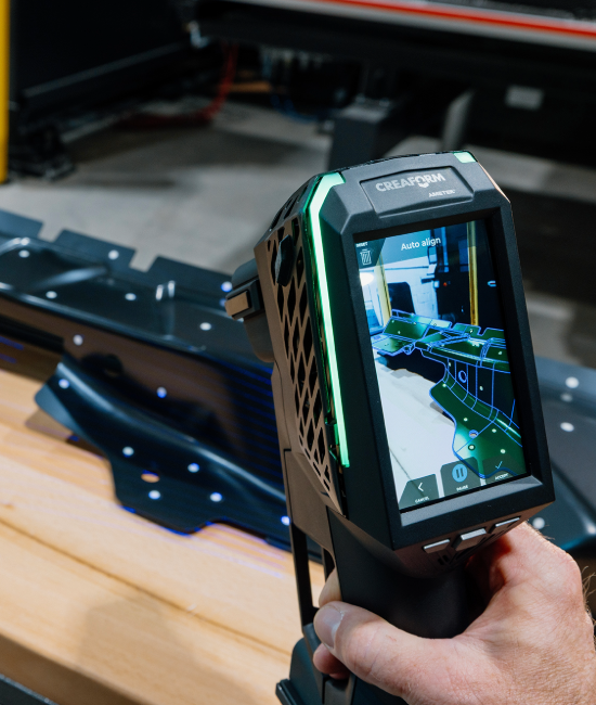 EVO Series 3D scanner showing auto alignment on screen while inspecting a sheet metal part