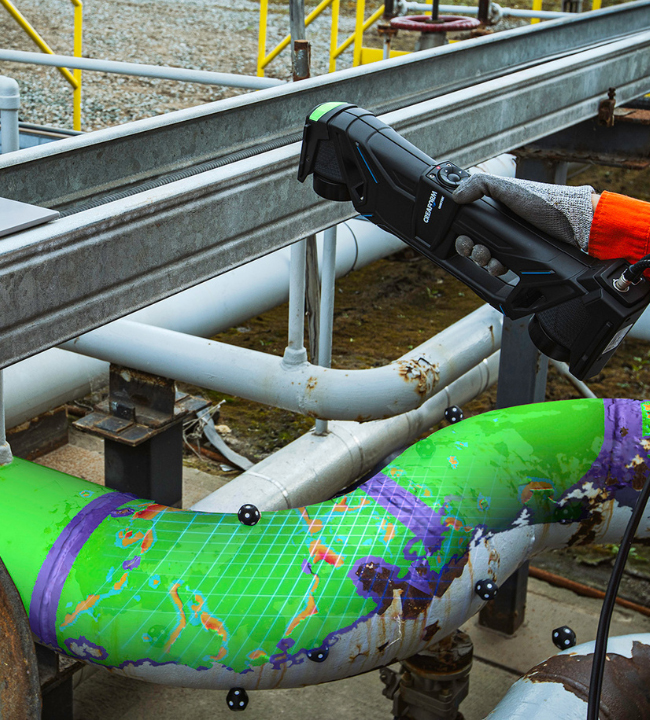 Someone scanning a pipeline elbow using the HandySCAN 3D MAX scanner