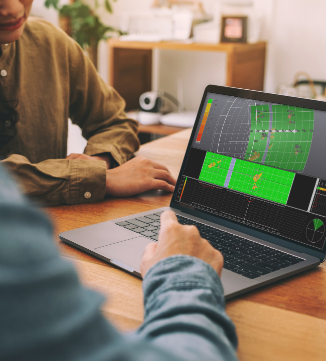 two men looking at pipeline analysis on a laptop