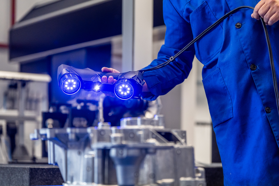 Operator using the Creaform HandySCAN 3D to inspect casting dimensions on the shop floor