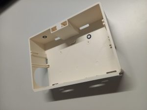 White plastic mousetrap on desk no lid