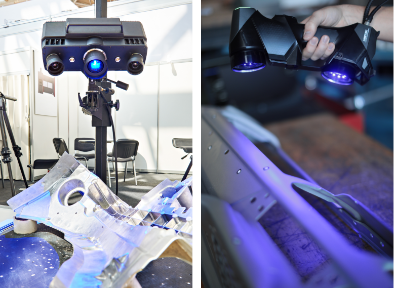 Black blue-light optical 3D measuring systems attached to a stand scanning a pressed metal part with table and chairs in the background and a Hand holding a HandySCAN3D-BLACK-Elite scanning a car part placed on a table