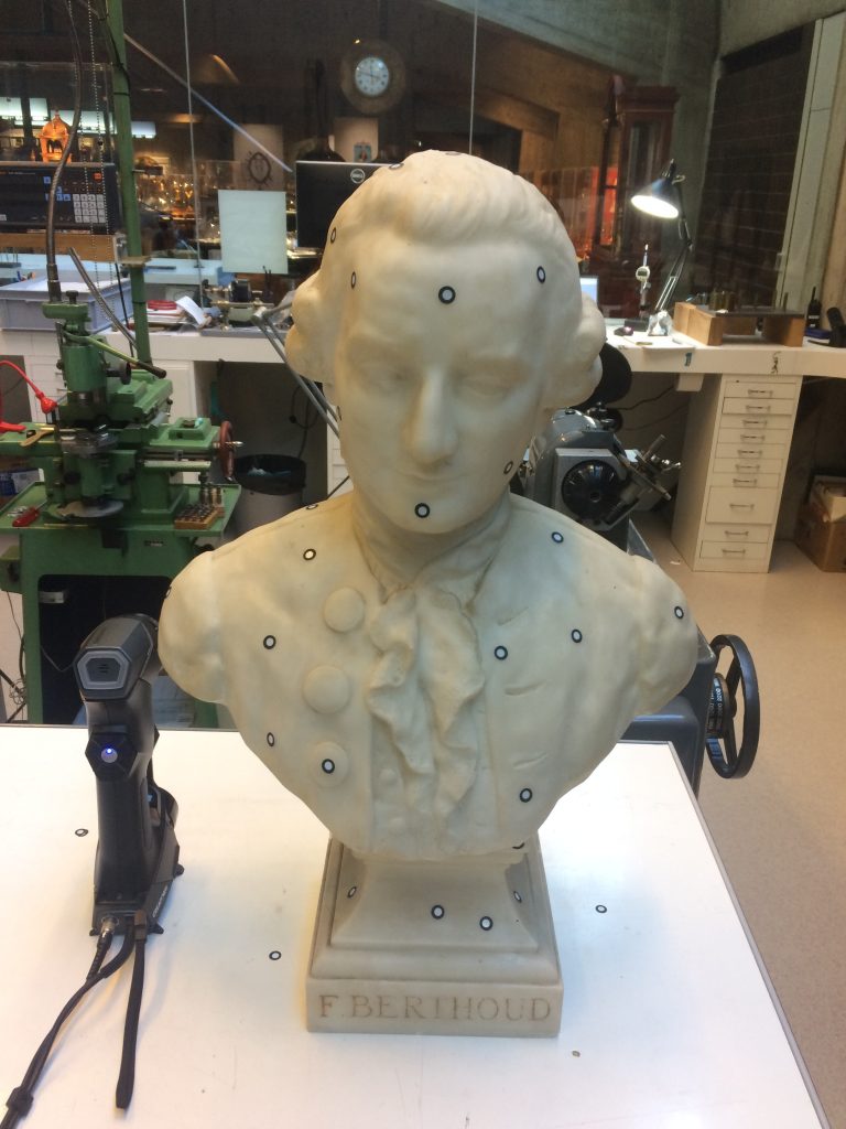 Bust of Ferdinand Berthoud in a workshop on a table next to a handySCAN 3D BLACK