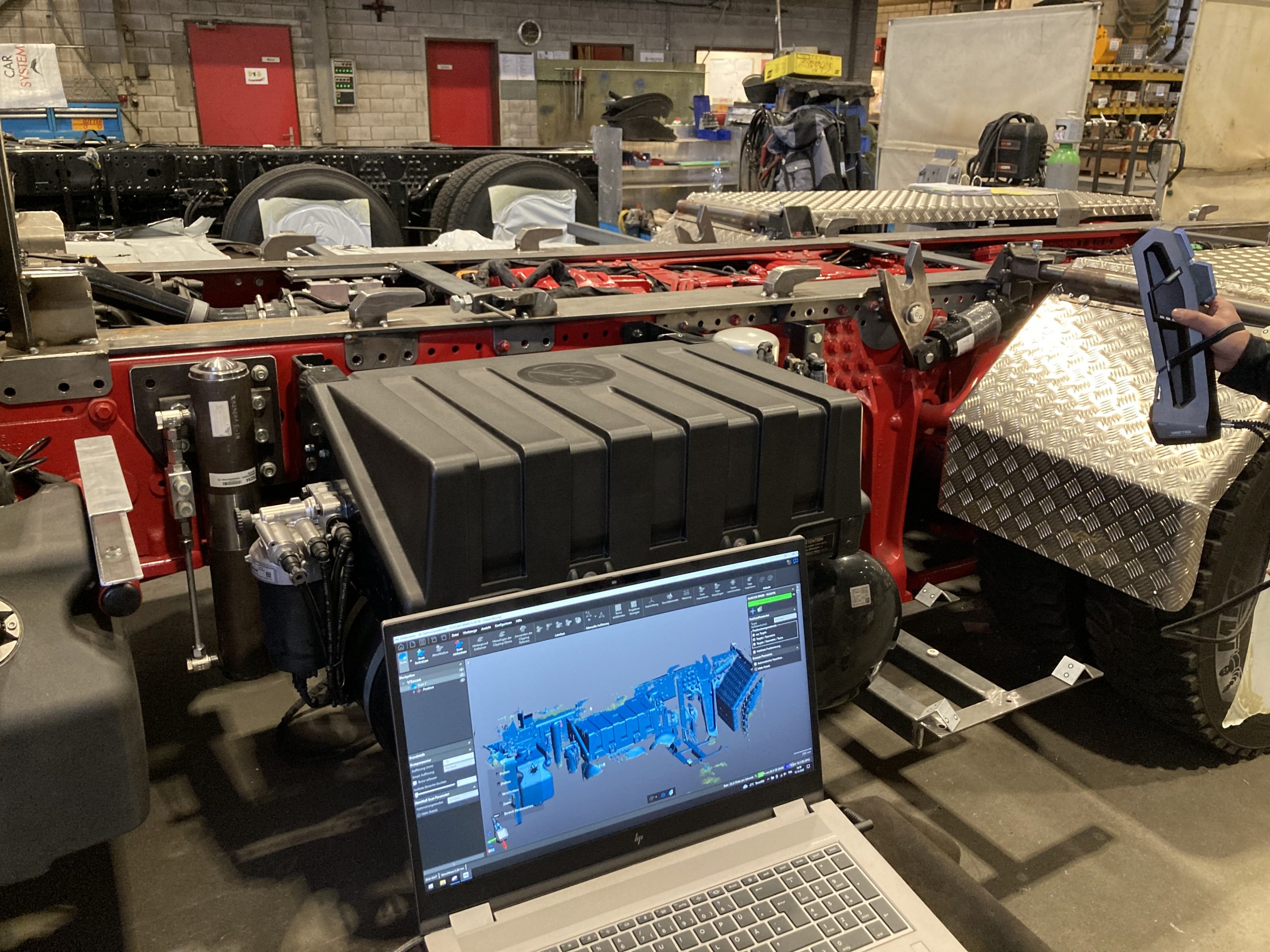 Go!SCAN SPARK scans truck chassis bodies. In the foreground is a laptop showing the scan.