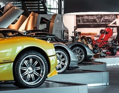 Several cars, motorcycle and pictures in the Pagani Museum